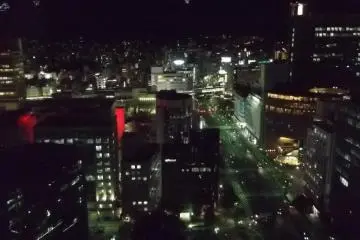 Looking north at night, with illuminated shapes that appear to be suspended over the city
