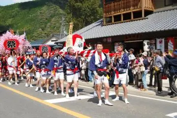 Groups of girls and boys, women and men carry a mikoshi (portable shrine), or in the case of the men, a big sake barrel