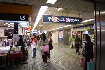 Keep following them until you head down some stairs to this area with stalls