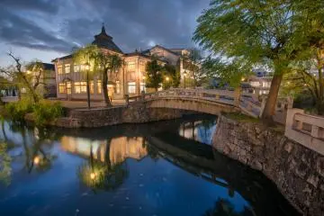 A nighttime view of the central bridge and canal