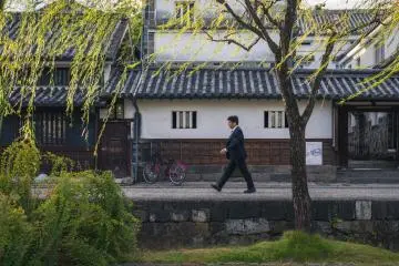 A business man walks along the quarter's canal