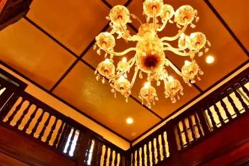 A lovely chandelier hangs from the ceiling