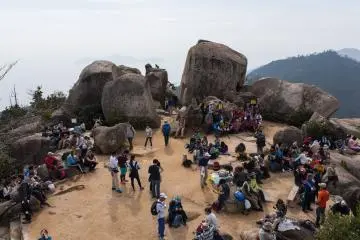 The top of Mt. Misen, walkers sprawled out taking in the view