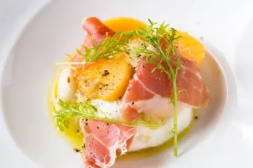 Burrata, persimmon, arugula, prosciutto, and turnip.