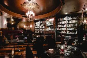 Cigar Bar Lounge with piano and books