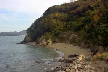 A small, secluded beach. You can see Shido Bay far in the distance to the left