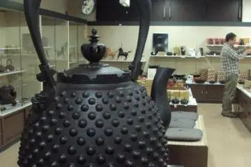 A large iron teapot is located in the gift shop. Similar, though smaller, teapots are made in one of the village's shops.