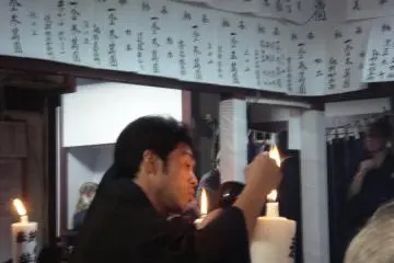 Candles are lit around the stage and in the room