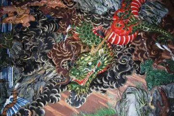 Scene from the carved ceiling showing a dragon fighting a tiger