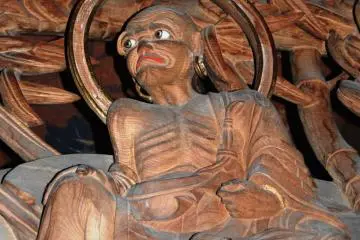 Do we see a monk here with some big earrings?