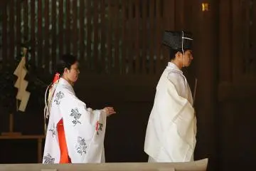 Meiji Shrine (Photo: <a href="https://commons.wikimedia.org/wiki/Category:Meiji_Shrine#/media/File:Kannushi_and_miko_at_the_Meiji_Shrine,_Tokyo.jpg" target="_blank" rel="noreferrer noopener nofollow">mrhayata, Shinto Priest, CC BY-SA 2.0 </a>)