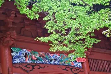 Green trees flank the beautiful red gate