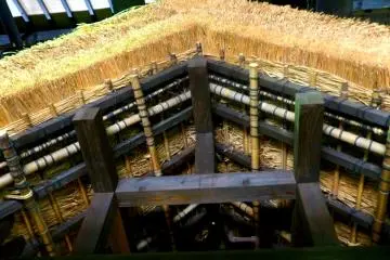 A thatched roof is sheltered inside the main building