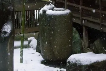 Traditional bamboo water feeder frozen in the snow
