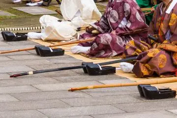 Lacquered shoes and bamboo bows; note the black-and-white one, the most elegant and valuable