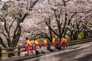 Several colorfully dressed entertainers making their way up to the castle entrance