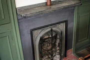The whole building was heated by this fireplace. A gap was left above the doorway on the stairs to let the heat rise.