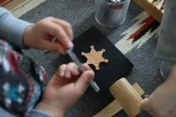 Making your own leather key chain by imprinting letters of symbols on it