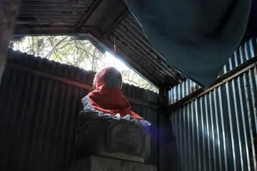Behind the compounds are various metal sheds with Buddhist statuary concealed behind curtains