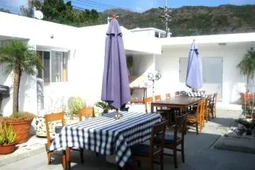 Beautiful Courtyard Tables is a great place to relax day or night at Half Time Pension Dive Shop and Bar at Aharen Beach