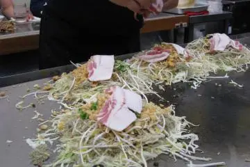 Okonomiyaki is prepared with many ingredients