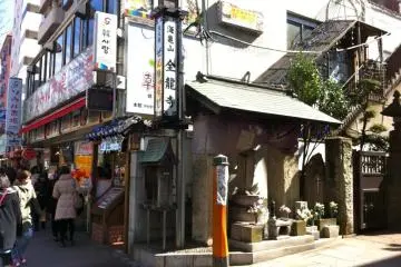 Edge of the building on the right as you walk up past the shrine