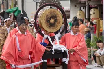 Priests push an instrument through the streets
