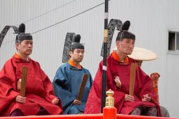 The lords ride atop a float near the rear of the procession