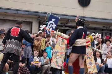 A sabre dancer waves to the crowd