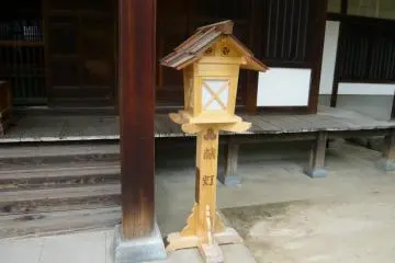 An elaborate wooden lantern at Yu Jinja