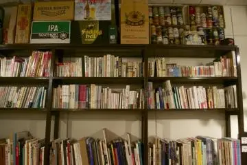 A wall of books that has since been replaced with a door to a newly added second room.