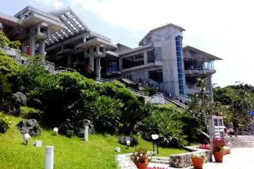 Tropical Plants dot the grounds of the Okinawa Churaumi Aquarium with its geometric and almost Aztec looking restaurant and shopping complex