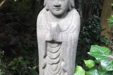 A statue among the greenery