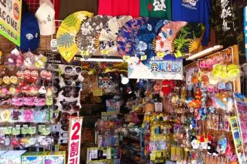 Shisa Dolls T Shirts and Okinawan food  for sale at the souvenir shop next to Shuri Castle its bright colors reminescent of a Taipei or Mongkok Market