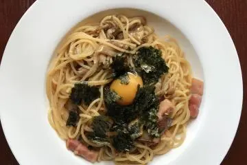Japanese pasta with egg yolk, bacon, seaweed and mushroom