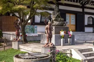 Another deity statue sits alongside the Buddha's feet to the side of the temple's museum