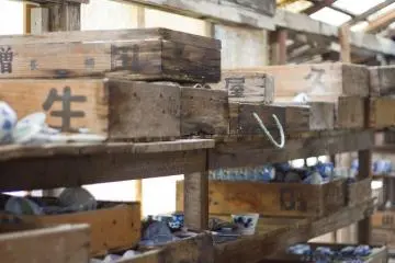 Storage crates in the showroom with some of the maker's last products