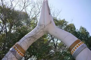 The entrance to the temple at the other side has huge hands in praying gesture