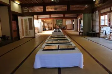 The previous dining area holds an art exhibit of the previous owner