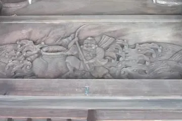 A fisherman, possibly Yebisu himself, with some rough seas around him