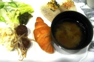 Complementary Breakfast with croissants potato salad onegiri and miso soup is served at the Toyoko Inn Nihonbashi