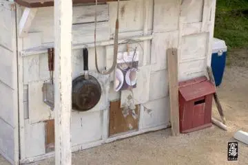 Frying pans, eucalyptus, and more decorate the walls of a stall on the cafe's grounds