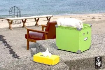 A tissue and towel box wait ready for customers alongside the ocean