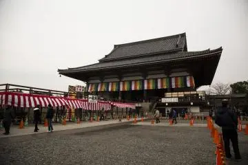 Barricades are set up around the raised platform outside Dai-Hondo, the main hall, before the bean throwing event. Crowds gather almost an hour before the ceremony to secure prime spots for catching the beans.