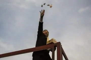 A celebrity throwing bean packets to the crowd. There were about four waves of celebrities who came out during the 40-minute event.