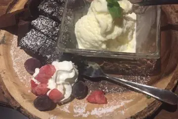 Tasty brownies with ice cream and fruit