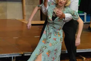 Nigel Rancour catching the young Hope after she faints, while trying not to waste a good martini