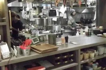 The kitchen is slightly open there behind the serving hatch