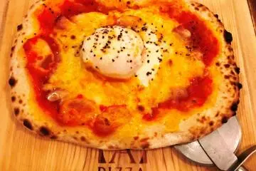 as soft cooked runny eggs, a nod to oyakodon, a classic Japanese dish.