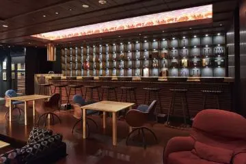 Take a sip at the bar while you watch a performance